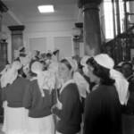 TUA21 Dental nurses from all over the country marched to Parliament in March 1974, to pressure the Government to restore their wage relativity with public health nurses. MPs were heard to comment: “It’s marvellous. They are so neat and tidy.” In any event they won relativity. Nurses are shown in Parliament building<br /><br />KEITH STEWART TUA21