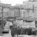 In Wellington workers stop work and march to the Employers Federation office protesting about the use of injunctions preventing workers withdrawing there labour. The march was also in solidarity with Bill Andersen imprisoned for defying a Supreme Court injunction.
