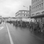 In Wellington workers stop work and march to the Employers Federation office protesting about the use of injunctions preventing workers withdrawing there labour. The march was also in solidarity with Bill Andersen imprisoned for defying a Supreme Court injunction.