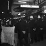 American Independence Day ball in 1973 at the Majestic Cabaret, Willis St, Wellington. Demonstrators voice their disagreement with USA involvement in the Vietnam war.