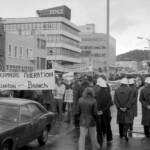 In Wellington workers stop work and march to the Employers Federation office protesting about the use of injunctions preventing workers withdrawing there labour. The march was also in solidarity with Bill Andersen imprisoned for defying a Supreme Court injunction.