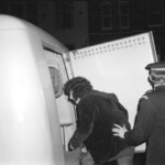 American Independence Day ball in 1973 at the Majestic Cabaret, Willis St, Wellington. Demonstrators voice their disagreement with USA involvement in the Vietnam war.