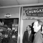 American Independence Day ball in 1973 at the Majestic Cabaret, Willis St, Wellington. Demonstrators voice their disagreement with USA involvement in the Vietnam war.