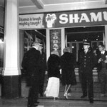 American Independence Day ball in 1973 at the Majestic Cabaret, Willis St, Wellington. Demonstrators voice their disagreement with USA involvement in the Vietnam war.