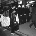 American Independence Day ball in 1973 at the Majestic Cabaret, Willis St, Wellington. Demonstrators voice their disagreement with USA involvement in the Vietnam war.