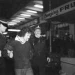 American Independence Day ball in 1973 at the Majestic Cabaret, Willis St, Wellington. Demonstrators voice their disagreement with USA involvement in the Vietnam war.