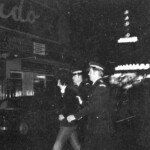 American Independence Day ball in 1973 at the Majestic Cabaret, Willis St, Wellington. Demonstrators voice their disagreement with USA involvement in the Vietnam war.