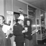 American Independence Day ball in 1973 at the Majestic Cabaret, Willis St, Wellington. Demonstrators voice their disagreement with USA involvement in the Vietnam war.