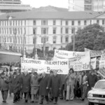 In Wellington workers stop work and march to the Employers Federation office protesting about the use of injunctions preventing workers withdrawing there labour. The march was also in solidarity with Bill Andersen imprisoned for defying a Supreme Court injunction.