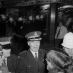 American Independence Day ball in 1973 at the Majestic Cabaret, Willis St, Wellington. Demonstrators voice their disagreement with USA involvement in the Vietnam war.