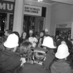 American Independence Day ball in 1973 at the Majestic Cabaret, Willis St, Wellington. Demonstrators voice their disagreement with USA involvement in the Vietnam war.
