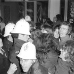 American Independence Day ball in 1973 at the Majestic Cabaret, Willis St, Wellington. Demonstrators voice their disagreement with USA involvement in the Vietnam war.
