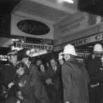American Independence Day ball in 1973 at the Majestic Cabaret, Willis St, Wellington. Demonstrators voice their disagreement with USA involvement in the Vietnam war.