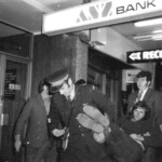 American Independence Day ball in 1973 at the Majestic Cabaret, Willis St, Wellington. Demonstrators voice their disagreement with USA involvement in the Vietnam war.