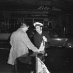 American Independence Day ball in 1973 at the Majestic Cabaret, Willis St, Wellington. Demonstrators voice their disagreement with USA involvement in the Vietnam war.