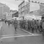 In Wellington workers stop work and march to the Employers Federation office protesting about the use of injunctions preventing workers withdrawing there labour. The march was also in solidarity with Bill Andersen imprisoned for defying a Supreme Court injunction.