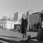 On Anzac Day in 1973 there was wreath laying by a number of countries at the Wellington Cenotaph. After the main ceremony a wreath was laid at the Wellington Cenotaph on behalf of the Victoria University Students Association. Peter Wilson, President of VUWSA addresses the crowd.